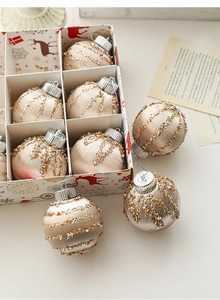 Champagne gold Christmas balls with glitter stripes on elegant holiday tree ornaments