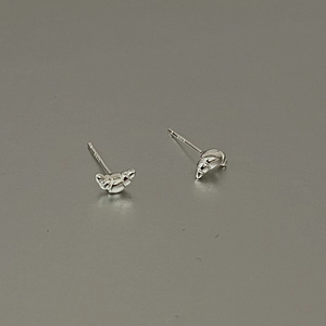 Detail shot of croissant-style S925 sterling silver stud earrings with a glossy finish