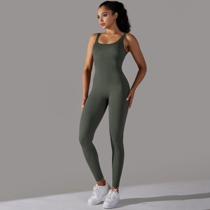 Detail of dark green ribbed knit fabric on a seamless athletic one-piece yoga jumpsuit