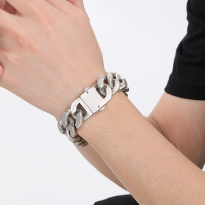 Detailed close-up of a 20mm polished stainless steel Cuban link bracelet for men