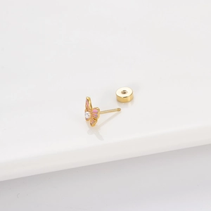 Golden butterfly stud earring with pink enamel wings and a centered pearl on white background