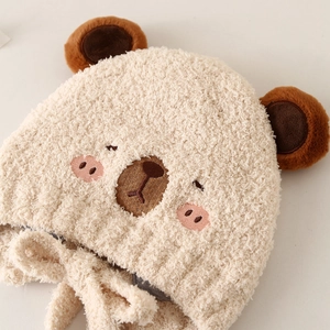 Plush beige baby winter knit hat featuring cute bear ears and protective ear flaps