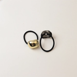 Polished gold and silver bean-shaped charms on high-elastic black hair ties