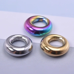 Detailed macro view of 304 stainless steel hollow ring charms in rainbow, gold, and silver
