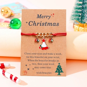 Red woven Christmas bracelet with enamel pendants on a kraft card display