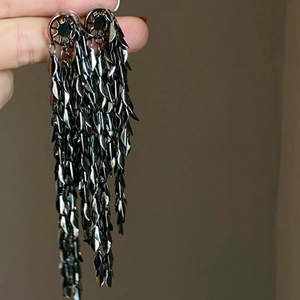 Elegant gun black long tassel earrings with leaf-shaped metal layers in a cascading design