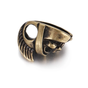 Macro detail of Spartan helmet skull bead in 18K gold plated copper with intricate carving
