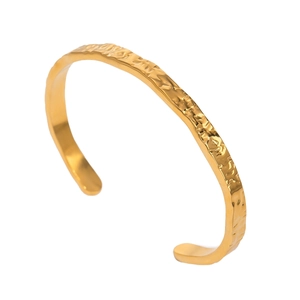 Gold wavy textured open cuff bracelet in minimalist stainless steel for women