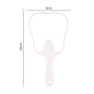 White tooth-shaped handheld mirror with handle measuring sixteen cm in height and nine cm wide
