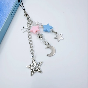 Y2K phone charm detail with silver metal stars, pink beads and crystals on blue phone case
