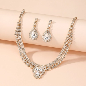 Detailed view of elegant gold rhinestone necklace and teardrop earrings jewelry set