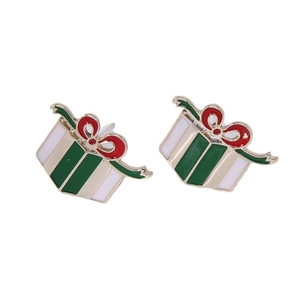 Detailed view of Christmas gift box earrings with green enamel and a red bow decoration