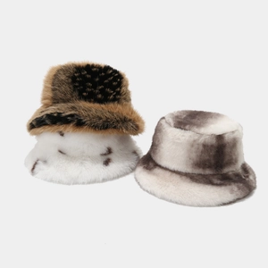 Close-up of fluffy faux fur bucket hats in leopard, white, and marble textures