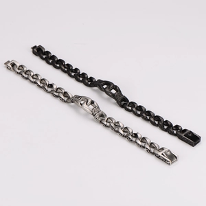 Detail view of vintage totem chain bracelets in silver and black with mechanical textures