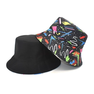 Set of two bucket hats showing plain black and colorful graffiti print in cotton canvas
