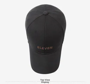 Top view of a black cotton baseball cap featuring brown 'ELEVEN' letter embroidery