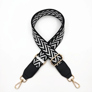 Adjustable black and white houndstooth bag strap with gold metal swivel snap hooks
