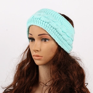 Detail of mint green cable knit ear warmer headband on a mannequin head profile