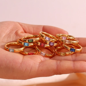 Stack of gold plated stainless steel rings with colorful rectangular zircon gemstones