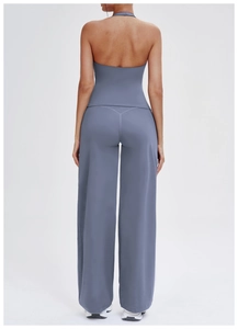Back view of high-waist flared yoga pants and backless halter top in dusty blue