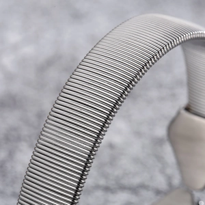 Macro detail of silver punk snake head bracelet showing flexible steel mesh texture