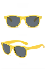 Detail view of yellow frame sunglasses with gray lenses and metallic rivet accents