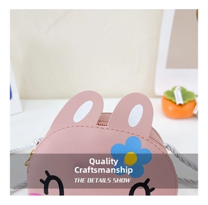 Detail of pink cartoon rabbit girls crossbody bag with cute ears and braided strap
