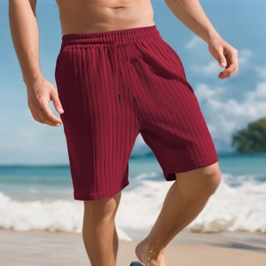 Men's dark red striped textured beach shorts with drawstring elastic waist in outdoor scene