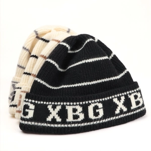Macro detail of knitted stripe texture and XBG lettering on the warm beanie hats