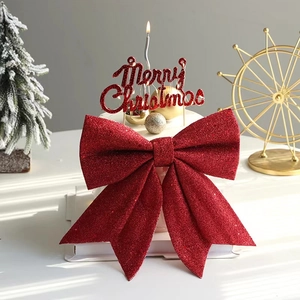 Red glitter Christmas bow cake topper with Merry Christmas text for festive baking decoration