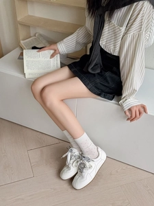 Close-up of white breathable mesh socks with polka dot pattern and stylish retro sneakers