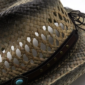 Detailed weave of Western straw cowboy hat with leather band and turquoise stud