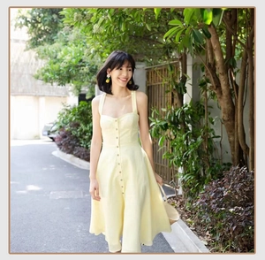 Detail of light yellow square neck button-down dress with a cinched waist and A-line cut