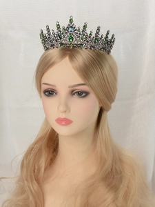 Detailed side view of a girls crown with green and blue crystals on a head model