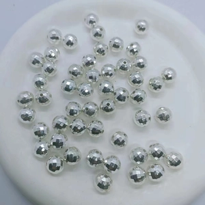 Close-up of faceted silver CCB loose beads for DIY jewelry making and craft projects