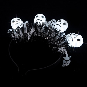Macro shot of Halloween headband featuring glowing white skulls and black fringe accents