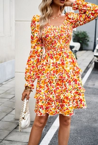Close-up of floral mini dress with puff sleeves, square neckline and tiered ruffle hemline