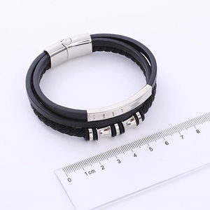 Macro detail of men's leather bracelet with stainless steel magnetic clasp and ruler