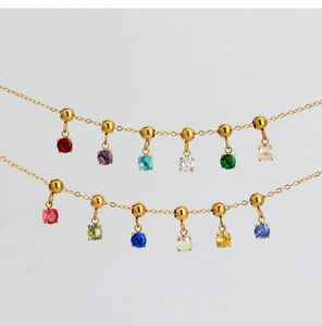 Close-up of 18K gold plated necklace featuring colorful round zircon gemstone pendants