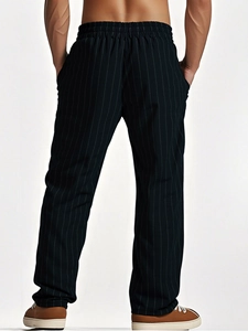 Detail view of men's linen striped trousers featuring elastic drawstring waist and back pocket