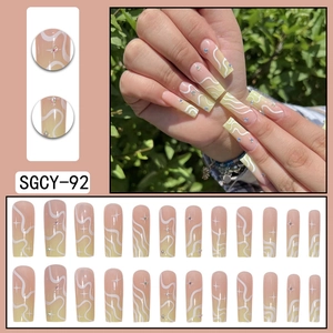 Long nude pink and yellow gradient press-on nails with wave lines and star rhinestones