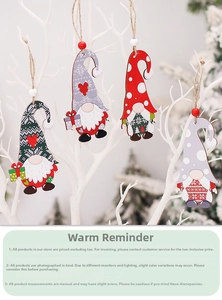 Close-up of four handmade Christmas gnome wood ornaments hanging with rustic hemp ropes