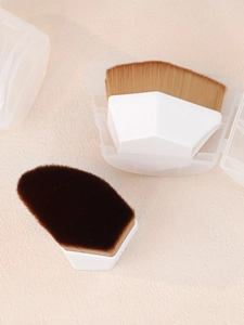 Detail view of the #55 hexagonal foundation brush with dense bristles and a clear storage case