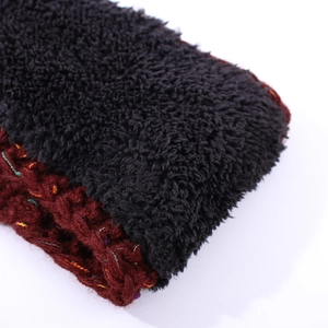 Close-up of thick knitted headband with warm fleece lining and colorful yarn accents