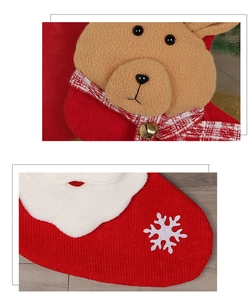 Detail of red corduroy Christmas stocking with plush reindeer and snowflake appliqué