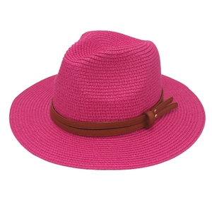 Detail of magenta woven straw fedora hat with brown leather belt and silver rivet accents