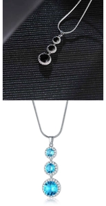 Detailed view of teardrop zircon necklaces in black and blue crystal variants