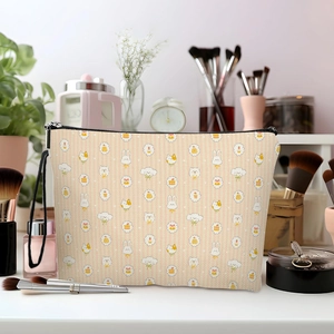 Cartoon animal printed makeup bag with top handle and black zipper closure on white desk
