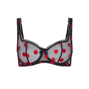 Detail of sheer black lace bra featuring red flocked polka dots and a bow accent