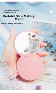 Close-up of pink portable sliding makeup mirror with dual-layer compact round design
